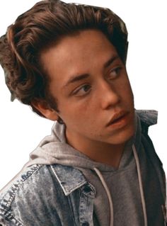 a young man wearing a denim jacket and hoodie looking at the camera with a serious look on his face