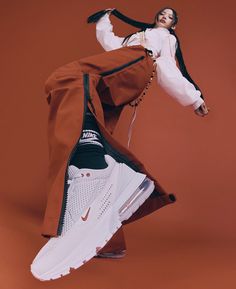 a woman in red pants and white sneakers