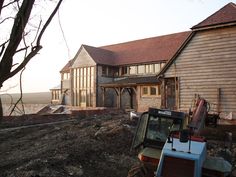 a tractor parked in front of a house under construction