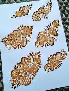 hendi tattoos on paper with gold and white designs