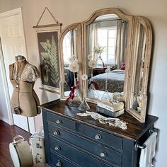 an antique dresser and mirror in a bedroom