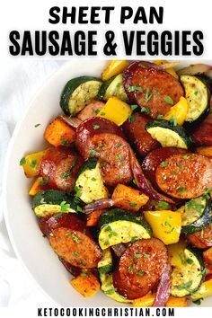 a bowl filled with sausage and veggies on top of a white tablecloth