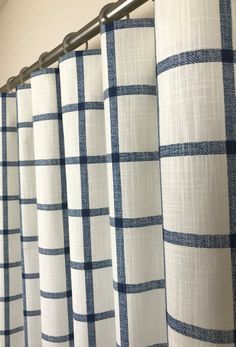 blue and white checkered curtains hanging on a rod