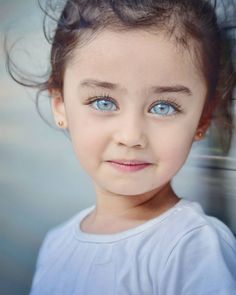 a close up of a child with blue eyes