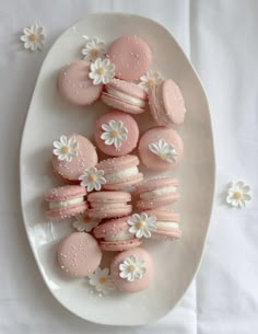 a white plate topped with pink and white macaroons