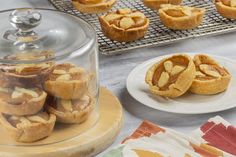 some pies are sitting on plates next to a glass dome