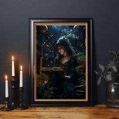 a woman reading a book in front of candles and a framed photograph on a table