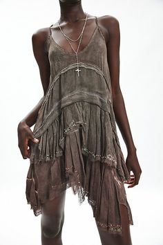 Boho Ecote mini dress in a shapeless, shift silhouette. Designed in a lightweight, floaty fabric featuring a plunging v-neckline, spaghetti straps and a racer back. Finished with cascading, spliced ruffles down the skirt & an asymmetric hanky hem. Exclusively at Urban Outfitters. Features Ecote Tabitha shapless tiered asymmetric mini dress Swing mini dress Lightweight floaty fabric Plunging v-neckline and spaghetti straps Tiered bodice and skirt Racer back Asymmetric hanky hem Swing a-line silhouette Mini length Easy pull-over style UO exclusive Content + Care 100% Rayon Machine wash Imported Size + Fit Model in Dark Green is 5’10" and wearing size Small Measurements taken from size Small Length: 31" | Ecote Tabitha Shapeless Tiered Asymmetric Mini Dress in Dark Grey, Women's at Urban Outf Sack Dress, Estilo Boho Chic, Whimsical Fashion, Urban Dresses, Mini Dress Shop, Flowy Dress, Boho Chic Fashion, Swing Dress, Ruffle Dress