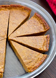 a pie sitting on top of a metal pan covered in sliced pumpkin pie crusts