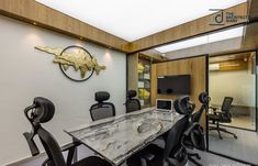 an office with marble table and black chairs