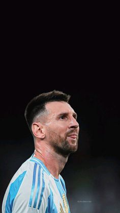 a close up of a soccer player wearing a blue and white uniform with his head tilted to the side