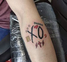 a man with a tattoo on his arm that says 40 and crosses, lightnings, hearts