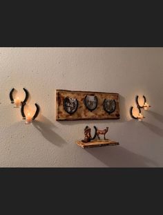 a couple of lights that are on the side of a wall with some pictures above them