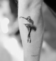 a black and white photo of a ballerina tattoo