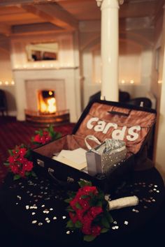 an open suitcase sitting on top of a table next to a candle and some flowers