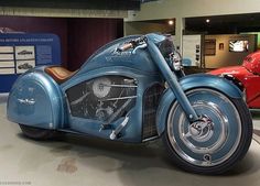 a blue motorcycle is on display in a museum