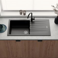 a black kitchen sink sitting on top of a counter