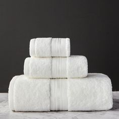 four white towels stacked on top of each other