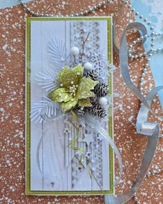 a close up of a card on a table with some ribbon and beads around it