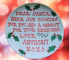 a christmas ornament hanging from the side of a glass plate with writing on it