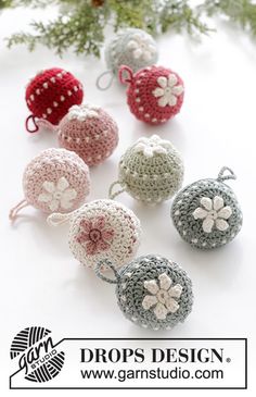 crocheted ornaments are arranged on a white surface