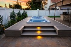 a hot tub sitting on top of a wooden deck