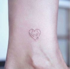 a small heart tattoo on the ankle