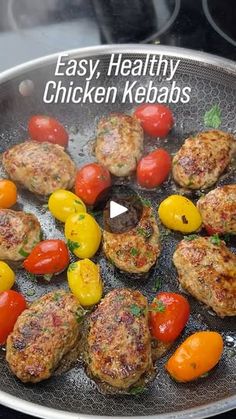 chicken kebabs with tomatoes and peppers cooking in a pan on the stove top