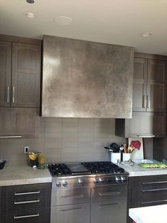 a modern kitchen with stainless steel appliances and wood cabinetry is pictured in this image