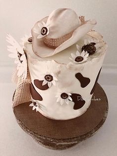 a cake decorated with white and brown decorations