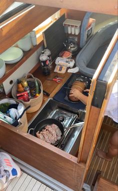 an open drawer on the side of a boat filled with food