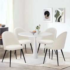 a white table with four chairs around it