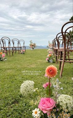 an outdoor ceremony set up with chairs and flowers