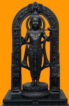 the statue is standing in front of an orange background