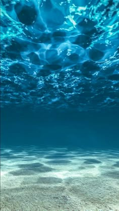 an underwater view of the ocean with blue water