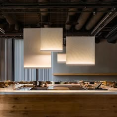 the lights are hanging from the ceiling above the counter in the restaurant, which is decorated with wood planks