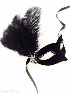 Feather Masquerade Mask in Black Velvet fabric adorned with Ostrich Plumes, beadwork, pearls and rhinestones. Elegant and beautiful addition to complete your beaded masquerade Ball Gown or Prom Masquerade Dress. Perfect for Flapper style Roaring 20s dresses! The Mask colors can be customized. Lightweight base in soft black velvet fabric & embellished with Crystal rhinestones. You have the option to add feathers with matching bead-work. The Feather colors can be customized to match your dress Masquerade Mask Prom, Prom Masquerade, Mask Prom, Roaring 20s Dresses, Masquerade Mask Women, Masquerade Ball Masks, Black Masquerade, Black Masquerade Mask, Masquerade Dress