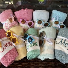 a basket filled with personalized towels and sunglasses