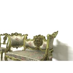 an ornately decorated bench against a white wall