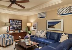 a living room filled with furniture and a flat screen tv mounted to the side of a wall