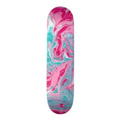 a skateboard with pink, blue and green paint on it's bottom half