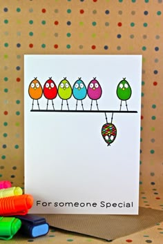 a card with four colorful birds on a line and the words, for someone special