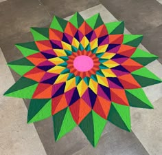 a multicolored flower is on the floor