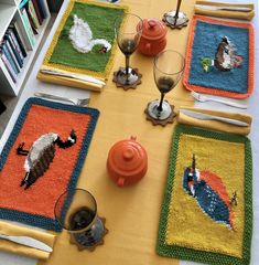 the table is set with place mats, cups and utensils