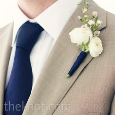 a man in a suit with a boutonniere on his lapel