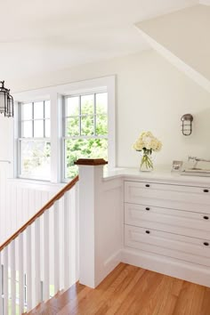 a room with white walls and wooden floors