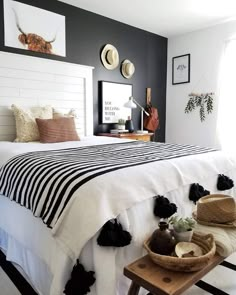 a bedroom with black and white decor on the walls