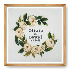 a cross stitched wedding card with white flowers