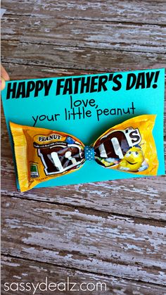 someone holding up a candy bar for father's day