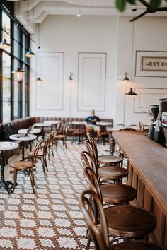 an empty restaurant with wooden tables and chairs